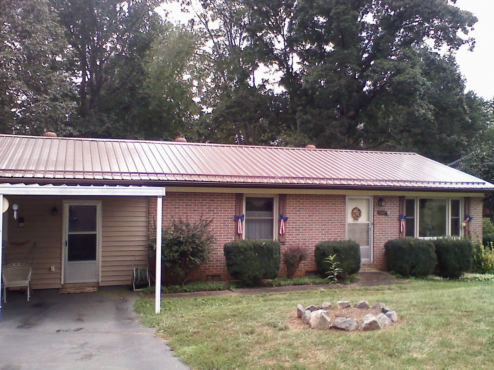Bronze metal roof and carport on a brick ranch home — Roof Repair work by our crew in Foothill Ranch
